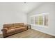 Cozy living room featuring a large window with plantation shutters for natural light control at 12546 108Th St, Largo, FL 33778