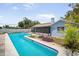 Backyard featuring a large in-ground pool, hot tub, and a charming patio area at 12546 108Th St, Largo, FL 33778