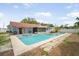 Backyard boasts a large in-ground pool, hot tub, and plenty of room to relax at 12546 108Th St, Largo, FL 33778