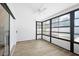 Bright sunroom featuring hardwood floors, a ceiling fan, and lots of windows at 12546 108Th St, Largo, FL 33778