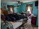 Cozy bedroom with blue walls and a ceiling fan at 12709 Greenland Dr, Riverview, FL 33579