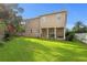 Beautiful backyard showcasing the home's rear exterior with a covered patio and well-maintained lawn at 131 Miramar Ne Blvd, St Petersburg, FL 33704
