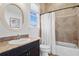 Traditional-style bathroom featuring a tiled shower with curtain and a vanity with drawers at 131 Miramar Ne Blvd, St Petersburg, FL 33704