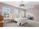 Bedroom with light pink walls, white wood trim, a modern light fixture, and large windows with shutters at 131 Miramar Ne Blvd, St Petersburg, FL 33704