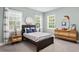 A charming bedroom with large windows, stylish décor, and a comfortable bed creating a cozy and inviting space at 131 Miramar Ne Blvd, St Petersburg, FL 33704
