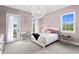 Bedroom with light pink walls, a decorative light fixture, and french doors at 131 Miramar Ne Blvd, St Petersburg, FL 33704