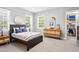 Light filled bedroom with windows, a closet with organized clothing, and an inviting atmosphere for rest and relaxation at 131 Miramar Ne Blvd, St Petersburg, FL 33704