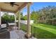 Inviting outdoor patio area featuring elegant columns, comfortable seating, and a view of the backyard at 131 Miramar Ne Blvd, St Petersburg, FL 33704