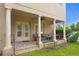 Charming covered patio featuring elegant columns, brick flooring, and comfortable seating, perfect for outdoor living at 131 Miramar Ne Blvd, St Petersburg, FL 33704