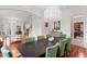 Formal dining room featuring a modern chandelier, hardwood floors, and seating for eight at 131 Miramar Ne Blvd, St Petersburg, FL 33704
