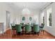 Bright dining room boasting hardwood floors, a modern chandelier, and seating for six at 131 Miramar Ne Blvd, St Petersburg, FL 33704