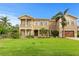 Luxury two-story home with manicured lawn, beautiful landscaping, balconies, and a two-car garage at 131 Miramar Ne Blvd, St Petersburg, FL 33704