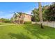A shot of the side of a two story home, with a well manicured lawn, and two palm trees on the property at 131 Miramar Ne Blvd, St Petersburg, FL 33704