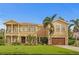 Stately two-story home with a well-manicured lawn, swaying palms, and a two-car garage at 131 Miramar Ne Blvd, St Petersburg, FL 33704