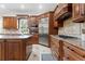 Spacious kitchen features wooden cabinets, stainless steel refrigerator, granite counters and tile flooring at 131 Miramar Ne Blvd, St Petersburg, FL 33704
