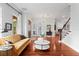 Cozy living room featuring an inviting mustard sofa, hardwood floors, and views of the backyard at 131 Miramar Ne Blvd, St Petersburg, FL 33704