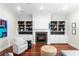 Cozy living room with a fireplace, built-in shelving, and comfortable seating at 131 Miramar Ne Blvd, St Petersburg, FL 33704