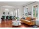 Stylish living room showcasing a mustard-colored sofa, hardwood floors, and abundant natural light at 131 Miramar Ne Blvd, St Petersburg, FL 33704