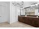 Modern main bathroom featuring dual sinks, granite countertops, a chandelier, and vanity with drawers at 131 Miramar Ne Blvd, St Petersburg, FL 33704