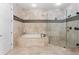 Modern main bathroom with tub, glass shower, and mosaic tile accents and patterns at 131 Miramar Ne Blvd, St Petersburg, FL 33704