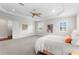 Spacious main bedroom with a ceiling fan, white walls, windows with shutters, and light gray carpet at 131 Miramar Ne Blvd, St Petersburg, FL 33704