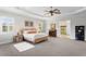 Spacious main bedroom with a ceiling fan, white walls, windows with shutters, and light gray carpet at 131 Miramar Ne Blvd, St Petersburg, FL 33704