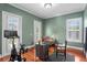 Home office space boasts wood floors, neutral paint, large windows, and a modern desk at 131 Miramar Ne Blvd, St Petersburg, FL 33704