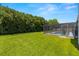 Lush backyard featuring a screened pool enclosure providing a private oasis for outdoor enjoyment at 14164 Fennsbury Dr, Tampa, FL 33624