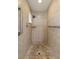 Shower with beige tile, stone floor and mounted shower head at 14164 Fennsbury Dr, Tampa, FL 33624