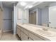 Bright bathroom with white double vanity and sink, a tiled shower in an open concept design at 14164 Fennsbury Dr, Tampa, FL 33624