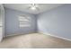 Well lit bedroom with fan, neutral color scheme, a window, and tile flooring at 14164 Fennsbury Dr, Tampa, FL 33624