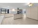 Kitchen showcasing expansive tiled floors, island cooktop, ample storage, and stainless appliances at 14164 Fennsbury Dr, Tampa, FL 33624