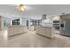 Open kitchen featuring a central island with an cooktop, tiled floor, and ample counter space at 14164 Fennsbury Dr, Tampa, FL 33624