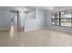 Bright, neutral living area featuring tile floors, light blue walls, and a large window with great natural light at 14164 Fennsbury Dr, Tampa, FL 33624