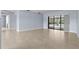 Spacious living room with neutral-toned tile flooring and large sliding doors providing access to pool area at 14164 Fennsbury Dr, Tampa, FL 33624