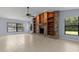 Spacious living room with custom built-in shelves surrounding a decorative fireplace, and large windows at 14164 Fennsbury Dr, Tampa, FL 33624