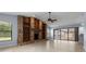 Spacious living room with a unique stone fireplace and sliding glass doors leading to the pool area at 14164 Fennsbury Dr, Tampa, FL 33624