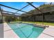 Beautiful screened-in pool with ample space for outdoor lounging and mature landscaping for privacy at 14164 Fennsbury Dr, Tampa, FL 33624
