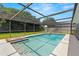 Sparkling screened pool with clear water, surrounded by ample deck space, and lush landscaping at 14164 Fennsbury Dr, Tampa, FL 33624