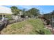 Expansive backyard featuring a tiered garden with wooden retaining walls and manicured landscaping at 159 Canby Cir, Spring Hill, FL 34606