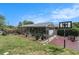 Large fenced-in backyard featuring a pool, covered lanai, grass, and a basketball court at 159 Canby Cir, Spring Hill, FL 34606