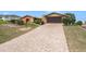 Charming single-Gathering home with brick driveway and attached garage, offering a well-maintained exterior and inviting curb appeal at 159 Canby Cir, Spring Hill, FL 34606