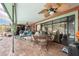 Inviting covered patio with outdoor seating, ceiling fan, and a view of the sparkling pool at 159 Canby Cir, Spring Hill, FL 34606