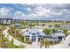 Community amenities view showcasing the lake, clubhouse, pool, and surrounding residential buildings at 1614 Running Tide Pl, Sarasota, FL 34240