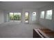Bright, unfinished living room with large windows and sliding doors offering views of lush greenery at 1614 Running Tide Pl, Sarasota, FL 34240