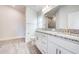 Bathroom boasts double granite vanity, white cabinetry, and tiled walk-in shower at 16425 66Th E Ln, Parrish, FL 34219