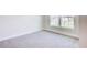Cozy bedroom with neutral carpeting, white trim, and a bright window with backyard views, creating a serene atmosphere at 16425 66Th E Ln, Parrish, FL 34219