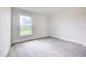 Neutral bedroom features plush carpet, bright window and white baseboards at 16425 66Th E Ln, Parrish, FL 34219
