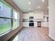 Bright kitchen with stainless steel appliances, granite countertops, and large windows that fill the space with light at 16425 66Th E Ln, Parrish, FL 34219