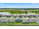 Aerial view of homes in the neighborhood with a pond and green space at 1829 Draughton Dr, Zephyrhills, FL 33541